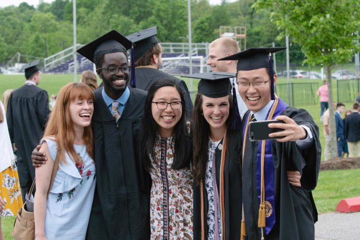 Asbury University graduates celebrating and taking a selfie