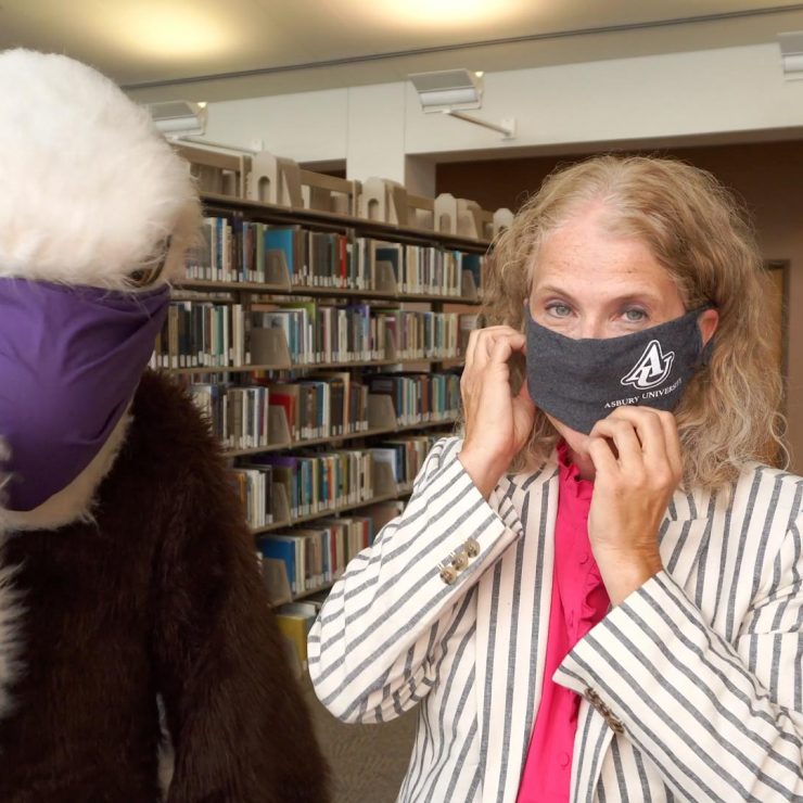 administrator and Eagles mascot wearing masks